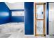 A well-appointed bathroom with a tub, wood-trimmed shower, and striking blue walls at 5071 Vinings Estates Se Ct, Mableton, GA 30126