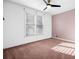 Bright, carpeted bedroom with neutral tones and a large window at 5071 Vinings Estates Se Ct, Mableton, GA 30126