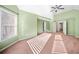 Spacious carpeted bedroom with a ceiling fan and vaulted ceiling, filled with natural light from large windows at 5071 Vinings Estates Se Ct, Mableton, GA 30126