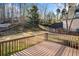 Wooden deck with railing overlooking the spacious, green backyard at 5071 Vinings Estates Se Ct, Mableton, GA 30126