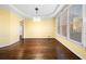 Bright dining room with hardwood floors, yellow walls, and natural light from large windows at 5071 Vinings Estates Se Ct, Mableton, GA 30126