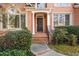 Welcoming front entrance with brick steps, columns, and lush greenery around the front door at 5071 Vinings Estates Se Ct, Mableton, GA 30126