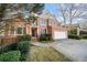 Charming two-story brick home with attached two-car garage and well-manicured landscaping at 5071 Vinings Estates Se Ct, Mableton, GA 30126