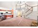 Open-concept living room with stairs, a kitchen view, and hardwood floors at 5071 Vinings Estates Se Ct, Mableton, GA 30126
