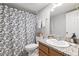 Bathroom with leafy shower curtain, wood vanity, and granite countertop at 106 Brighton Pt, Atlanta, GA 30328