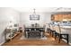Dining area with seating for six, stylish light fixture, and breakfast bar overlooking the kitchen at 106 Brighton Pt, Atlanta, GA 30328