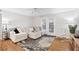 Cozy living room with a plush sofa, neutral tones, and a door leading to the outside at 106 Brighton Pt, Atlanta, GA 30328