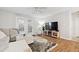 Bright living room features a comfortable sofa, large TV, and stylish decor at 106 Brighton Pt, Atlanta, GA 30328