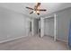 Spacious bedroom with neutral carpeting, ceiling fan, and walk-in closet at 1358 Mckinsey Rdg, Loganville, GA 30052