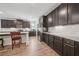 Open kitchen featuring dark cabinetry, granite countertops, stainless appliances, and island seating at 158 Rolling Hills Pl, Canton, GA 30114