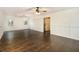 Bright living room featuring hardwood floors, paneled walls, stylish light fixture, and a sliding barn door to a kitchen at 170 Gilreath Nw Rd, Cartersville, GA 30121