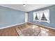 Light-filled bedroom featuring hardwood floors and soft blue walls at 2345 Henderson Mill Ne Rd # 1, Atlanta, GA 30345