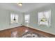 Bedroom features hardwood floors and two bright windows at 2345 Henderson Mill Ne Rd # 1, Atlanta, GA 30345