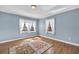 Sunny bedroom with hardwood floors, bright windows, and a decorative area rug at 2345 Henderson Mill Ne Rd # 1, Atlanta, GA 30345