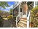 Exterior view of unit showing brick foundation, staircase, and screened porch at 2345 Henderson Mill Ne Rd # 1, Atlanta, GA 30345