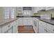 Well-lit kitchen boasts white cabinets, black countertops, and modern appliances at 2345 Henderson Mill Ne Rd # 1, Atlanta, GA 30345