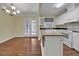 Eat-in kitchen featuring white cabinetry, stainless appliances, and hardwood floors at 2345 Henderson Mill Ne Rd # 1, Atlanta, GA 30345