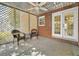 View of screened in porch with brick wall, concrete floor and two wicker chairs at 2345 Henderson Mill Ne Rd # 1, Atlanta, GA 30345