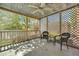 View of screened in porch with concrete floor and two wicker chairs at 2345 Henderson Mill Ne Rd # 1, Atlanta, GA 30345