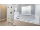 Bathroom featuring a glass shower and a deep soaking tub at 3483 Summerlin Pkwy, Lithia Springs, GA 30122
