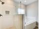 Modern bathroom featuring glass shower doors and a separate soaking tub at 3483 Summerlin Pkwy, Lithia Springs, GA 30122