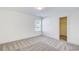 Bright bedroom features neutral carpet, a window for natural light, and a walk-in closet at 3483 Summerlin Pkwy, Lithia Springs, GA 30122