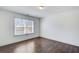 Well-lit bedroom featuring hardwood floors and a large window for ample sunlight at 3483 Summerlin Pkwy, Lithia Springs, GA 30122
