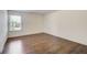 Bedroom featuring hardwood floors, white walls, and a window for natural light at 3483 Summerlin Pkwy, Lithia Springs, GA 30122