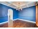 Formal dining room with coffered ceiling, hardwood floors and modern lighting fixture at 3483 Summerlin Pkwy, Lithia Springs, GA 30122