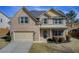 Charming two-story brick home with a well-manicured lawn and attached two-car garage at 3483 Summerlin Pkwy, Lithia Springs, GA 30122