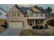 Charming two-story brick home with well-manicured lawn and attached two-car garage at 3483 Summerlin Pkwy, Lithia Springs, GA 30122