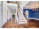 Inviting foyer featuring a staircase, hardwood floors, and modern lighting fixtures at 3483 Summerlin Pkwy, Lithia Springs, GA 30122