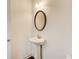 Clean half-bath with pedestal sink, oval mirror, and updated fixtures at 3483 Summerlin Pkwy, Lithia Springs, GA 30122