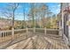 Wooden back deck with white railings overlooking a wooded backyard at 2021 Cockrell Pointe Nw, Kennesaw, GA 30152
