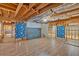 Partially finished basement with wooden beams and laminate flooring at 2021 Cockrell Pointe Nw, Kennesaw, GA 30152