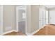 Inviting hallway with hardwood floors, neutral walls, and access to various rooms at 2021 Cockrell Pointe Nw, Kennesaw, GA 30152