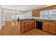Kitchen offers granite counters and wood cabinets, open to the living room with fireplace at 2021 Cockrell Pointe Nw, Kennesaw, GA 30152