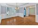 Traditional living room featuring large windows with light blue walls, white trim, and hardwood floors at 2021 Cockrell Pointe Nw, Kennesaw, GA 30152