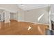 Bright, open-concept living room with hardwood floors, featuring fireplace, and ample natural light at 2021 Cockrell Pointe Nw, Kennesaw, GA 30152