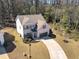 Aerial view of the two-story home with a well-manicured lawn and long driveway in a cul-de-sac at 2099 Easterwood Ter, Decatur, GA 30032