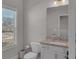 Modern bathroom featuring granite countertop, white cabinets and natural light from window at 2099 Easterwood Ter, Decatur, GA 30032