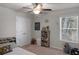 A bedroom featuring a ceiling fan, a closet, shelving and natural light from the window at 2099 Easterwood Ter, Decatur, GA 30032