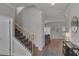 Bright foyer with hardwood floors, staircase, and view into the living room area at 2099 Easterwood Ter, Decatur, GA 30032