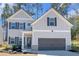 Charming two-story home featuring a grey siding, black shutters, and a convenient two-car garage at 2099 Easterwood Ter, Decatur, GA 30032