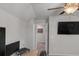 An office featuring a ceiling fan, a chair and desk setup, and a wall mounted television at 2099 Easterwood Ter, Decatur, GA 30032
