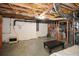 Unfinished basement with concrete floors and exposed wood rafters, perfect for storage or future customization at 120 Mill Creek Ct, Acworth, GA 30101