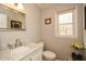 Charming half bathroom with marble vanity, natural light, and decorative accents at 120 Mill Creek Ct, Acworth, GA 30101