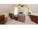Inviting bonus room features comfortable seating, a ceiling fan, and a TV for relaxing and unwinding at 120 Mill Creek Ct, Acworth, GA 30101