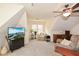 Cozy bonus room with sloped ceilings, ceiling fan, and plush seating for relaxation and entertainment at 120 Mill Creek Ct, Acworth, GA 30101