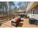 Relaxing outdoor deck with an umbrella-covered table and chairs, ideal for entertaining or enjoying nature at 120 Mill Creek Ct, Acworth, GA 30101